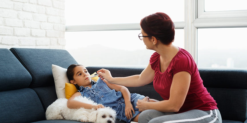 Mother Checking Temperature To Ill Daughter With Thermometer