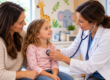 Pediatrician meeting with a parent and child during a routine well-child visit